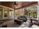 Comfortable covered patio with wood ceiling, stylish seating, coffee table, and views of backyard at 102 Kamprath Pl, Cary, NC 27519