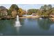 A community pond with a fountain and swimming pool are surrounded by tall mature trees at 102 Kamprath Pl, Cary, NC 27519