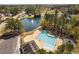 Aerial view of a community pool with lanes and a fountain in the adjacent lake, surrounded by trees and houses at 102 Kamprath Pl, Cary, NC 27519