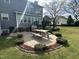 A backyard patio features a picnic table surrounded by attractive landscaping and greenery at 1020 Retriever Ln, Raleigh, NC 27603