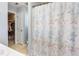 Bathroom featuring shower-tub combo with patterned shower curtain and a walk-in closet for ample storage at 1020 Retriever Ln, Raleigh, NC 27603