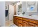 Bathroom featuring double sinks with wood cabinets, white countertops and framed mirrors offering plenty of space at 1020 Retriever Ln, Raleigh, NC 27603