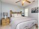 This primary bedroom has soft, neutral walls, a comfy bed, and a ceiling fan to keep you cool at night at 1020 Retriever Ln, Raleigh, NC 27603