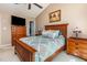 This is a cozy bedroom with an updated wooden bed frame, soft carpet, and neutral-colored walls at 1020 Retriever Ln, Raleigh, NC 27603