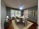 Dining room features a modern chandelier, hardwood floors, neutral walls, and seating for six guests at 1020 Retriever Ln, Raleigh, NC 27603