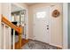 Inviting foyer showcasing hardwood floors, a staircase, and a decorative front door with glass panels at 1020 Retriever Ln, Raleigh, NC 27603