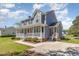 Charming two-story home features a spacious front porch, well-manicured lawn, and classic architectural details at 1020 Retriever Ln, Raleigh, NC 27603
