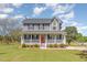 Charming two-story home features a spacious front porch, well-manicured lawn, and classic architectural details at 1020 Retriever Ln, Raleigh, NC 27603