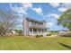 Charming two-story home features a spacious front porch, well-manicured lawn, and classic architectural details at 1020 Retriever Ln, Raleigh, NC 27603