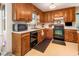 Well-lit kitchen with wood cabinets, updated appliances, and ample counter space for cooking and preparation at 1020 Retriever Ln, Raleigh, NC 27603