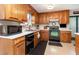 Kitchen featuring wood cabinets, modern appliances, and sleek countertops at 1020 Retriever Ln, Raleigh, NC 27603