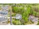 Scenic aerial view showcases home with golf course backdrop and immaculately landscaped yard with mature trees at 104 Vervain Way, Holly Springs, NC 27540