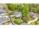 Charming aerial view showcases landscaped yard and mature trees within a desirable golf course community neighborhood at 104 Vervain Way, Holly Springs, NC 27540