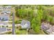 Expansive aerial view of a desirable golf course community with a beautifully landscaped yard and mature trees at 104 Vervain Way, Holly Springs, NC 27540