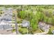 Scenic aerial view showcases a home with golf course backdrop and an immaculately landscaped yard with mature trees at 104 Vervain Way, Holly Springs, NC 27540