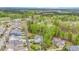 Expansive aerial view overlooking the charming home, lush green trees, golf course, and neighboring properties at 104 Vervain Way, Holly Springs, NC 27540