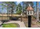 Beautiful backyard with a bench and birdhouse overlooking a golf course at 104 Vervain Way, Holly Springs, NC 27540