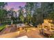 Expansive backyard featuring a hot tub, fireplace, hammock, and lounge chairs at 104 Vervain Way, Holly Springs, NC 27540