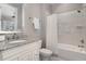 Bathroom with a granite countertop vanity, and a shower-tub combination with tiled walls at 104 Vervain Way, Holly Springs, NC 27540