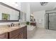 Spacious bathroom with a soaking tub, a separate shower, double vanity, and updated fixtures at 104 Vervain Way, Holly Springs, NC 27540