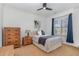Bedroom with a bed, dresser, and a window with blue curtains and plantation shutters at 104 Vervain Way, Holly Springs, NC 27540