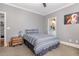 Bedroom with carpet, a bed, and a doorway leading to a bathroom with a view of the sink and vanity at 104 Vervain Way, Holly Springs, NC 27540