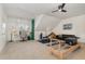 Bonus room with gym equipment, a desk, and a sofa; a versatile space for recreation and relaxation at 104 Vervain Way, Holly Springs, NC 27540