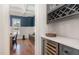 Butler's pantry features custom cabinetry, wine storage, and a view into the dining room at 104 Vervain Way, Holly Springs, NC 27540