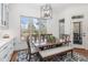Bright dining area with a large window, a wood table, and ample seating at 104 Vervain Way, Holly Springs, NC 27540