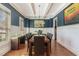 Formal dining room with wainscoting, coffered ceiling, and hardwood floors at 104 Vervain Way, Holly Springs, NC 27540