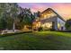 Stunning home exterior with pool, fire pit, green grass, and backyard patio at 104 Vervain Way, Holly Springs, NC 27540