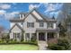 Charming stone-clad home with well-manicured lawn, covered entry, and seasonal wreaths hanging on the doors at 104 Vervain Way, Holly Springs, NC 27540