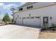 Three car garage with a concrete driveway at 104 Vervain Way, Holly Springs, NC 27540