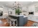 Open concept kitchen with a large island, stainless steel appliances, and white cabinetry at 104 Vervain Way, Holly Springs, NC 27540