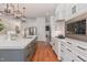 Well-equipped kitchen with stainless steel appliances, white cabinets, and a view of the dining area at 104 Vervain Way, Holly Springs, NC 27540