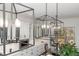 Bright kitchen showcasing modern pendant lights, white cabinets, and hardwood floors at 104 Vervain Way, Holly Springs, NC 27540