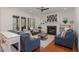 Bright living room with fireplace, large windows, and comfortable seating at 104 Vervain Way, Holly Springs, NC 27540
