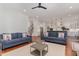 Open-concept living room with hardwood floors and view into the kitchen at 104 Vervain Way, Holly Springs, NC 27540