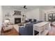 Bright living room featuring a fireplace, hardwood floors, and elegant furniture at 104 Vervain Way, Holly Springs, NC 27540