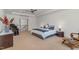 Expansive main bedroom with stairs nearby, bedside tables, and elegant decor at 104 Vervain Way, Holly Springs, NC 27540