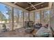 Relaxing screened porch with a stone floor and comfortable seating, perfect for enjoying the outdoors at 104 Vervain Way, Holly Springs, NC 27540