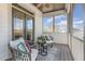 Relaxing screened porch featuring wicker furniture and comfortable cushions at 104 Vervain Way, Holly Springs, NC 27540