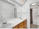 Well-lit bathroom with double vanity, a large mirror, and a shower with white walls at 105 Hobson Pl, Louisburg, NC 27549