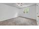 Bright bedroom with neutral carpet, ceiling fan, and natural light from a large window at 105 Hobson Pl, Louisburg, NC 27549
