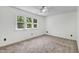 Neutral-colored bedroom with carpet and large windows providing natural light, ceiling fan at 105 Hobson Pl, Louisburg, NC 27549