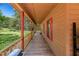 Expansive covered porch features wood flooring and red shutters, perfect for enjoying the outdoors at 105 Hobson Pl, Louisburg, NC 27549
