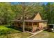 Charming two-story home with a covered porch and well-maintained lawn surrounded by lush trees at 105 Hobson Pl, Louisburg, NC 27549
