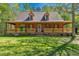 Charming two-story home featuring a covered front porch, dormer windows and mature trees at 105 Hobson Pl, Louisburg, NC 27549