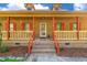 Inviting front porch welcomes you with its brick steps and warm wood tones at 105 Hobson Pl, Louisburg, NC 27549
