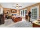 Cozy main bedroom with wooden chest at foot of bed, soft rug, shelves and plentiful natural light at 105 Hobson Pl, Louisburg, NC 27549